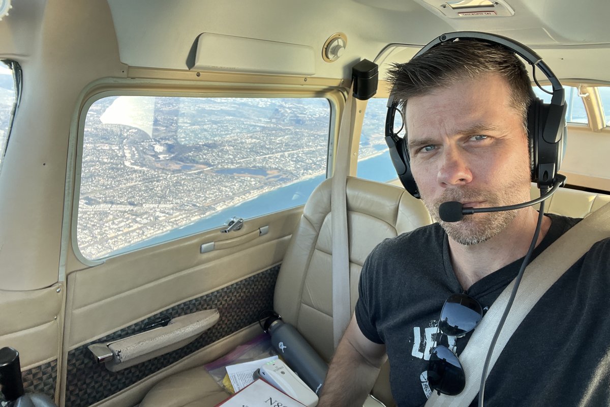 John Scott flying over the San Diego coastline.